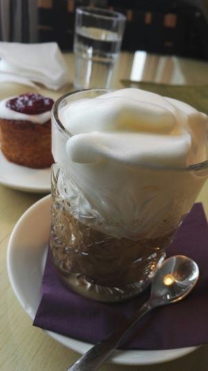 Soymilk Cappuccino /w seasonal treat in the back at Cafe Alvar in Jyvaskyla