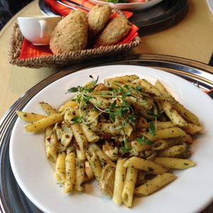 Vegan pasta with zucchini, artichokes, onion, cashew and herbs. at Cafe Alvar in Jyvaskyla