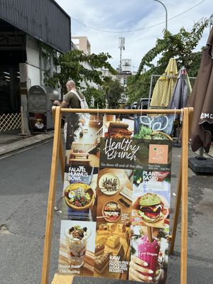 You see this sign in the middle of this alley  at Roots Plant-based Cafe - Hẻm 41 Xuan Thuy in Ho Chi Minh City