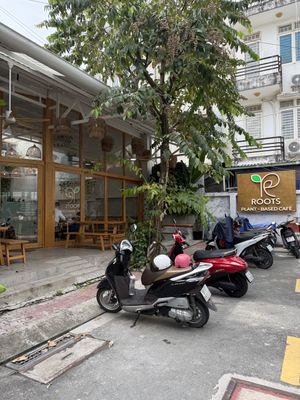 Entrance, parking and outdoor sitting area  at Roots Plant-based Cafe - Hẻm 41 Xuan Thuy in Ho Chi Minh City