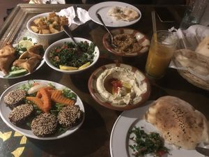 Falafel, spinach rolls, spicy potatoes, taboula, beirouti houmous, muhammara, fresh mango juice    at Taboula in Cairo