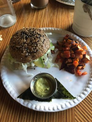 Tuna salad burger with chopped up carrots and sweet potatoes on the side at Casa Macro in Monterrey