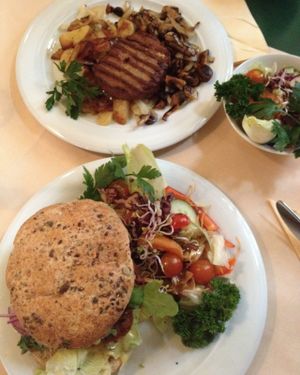 Vegan Kidney Chili Burger and vegan steak with salad. at Cafe Central in Flensburg