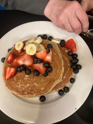 Pancake stack eith fresh fruit and maple syrup on the side at Fuel Cafe in Hicksville