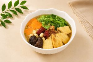 Herbal Noodle Soup: Yellow noodles, lotus seeds, fresh tofu skin, tofu, shiitake mushrooms, Chinese red dates, and carrots in herbal broth at Luong-Loi Restaurant in Wheaton