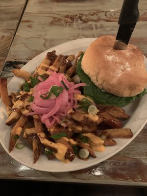 Burger with fries topped with cheese at MeeT on Main in Vancouver