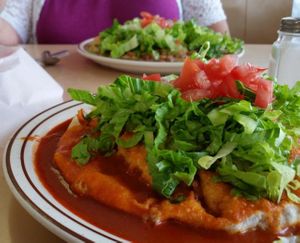 A typical plate setting shows a Navajo taco, a sopapilla and a fry bread. at Orphie's in Penasco