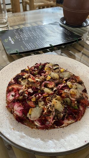 Vegan pizza 🍕 tastes amazing, but is very small    at Kaani Nilam - Auroville in Viluppuram
