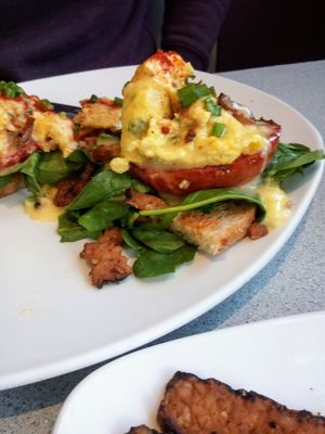 Just Egg Benedict with fire roasted tomato, vegan cheese sauce, tempeh bacon and more tempeh bacon on the side at Silver Diner in Cherry Hill