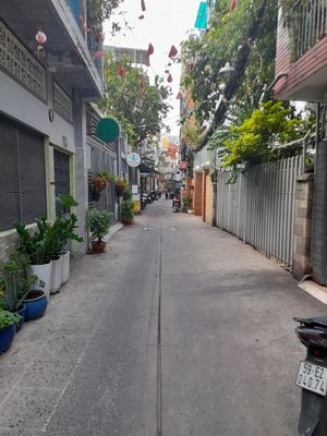 The main alleyway after leaving the main street. The restaurant is located on the left about 20 metres away. Look out for a yellow banh mi stall. at An Tinh Vegan Food  in Ho Chi Minh City