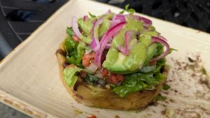 Sopes La Maria! Thick corn tortilla cups, no cheese/crema, refried/black beans, avocado, pico de gallo, & lettuce. Ask for hot sauce & pickled onions to maximize flavor!  at Manolete's Cocina Gourmet in Winchester