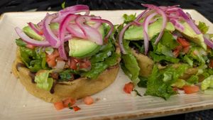 Sopes La Maria! Thick corn tortilla cups, no cheese/crema, refried/black beans, avocado, pico de gallo, & lettuce. Ask for hot sauce & pickled onions to maximize flavor!  at Manolete's Cocina Gourmet in Winchester