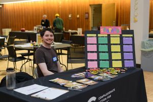 A volunteer at a vegan Jeopardy game at the beginning of the Vegan Chili Cook off. Kids Table in the background. at Compassionate Action for Animals in Minneapolis