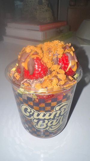 Create your own strawberry cup. This is with strawberry puree, vegan organic chocolate, crushed pistachios and biscoff crumble  at Crumb Bar in Edmonton