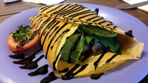 Tempeh and nut cheese spread with kale red onion and mushrooms drizzled with balsamic reduction at Firefly in West Seattle