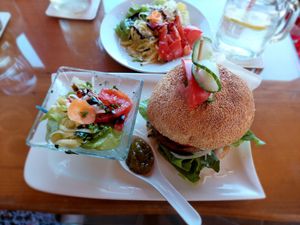 Vegan burger (wheat protein patty, hummus, homemade mustard mayonnaise sauce, horseradish, onions, cucumber) (the salad in the background was a separate order) at Mostheuriger Pihringer in Winklarn