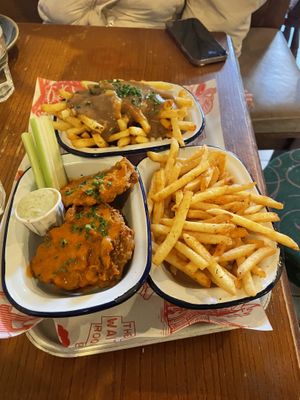 Back: Poutine, left: seitan wings with buffalo sauce, right: plain fries   at The Waiting Room in South East London