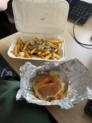 Back: poutine, Front: breakfast bagel. Both in takeaway boxes   at The Waiting Room in South East London
