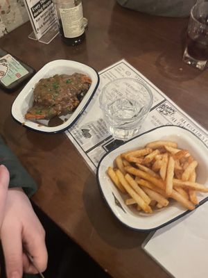 left: wings with gravy. right: fries  at The Waiting Room in South East London