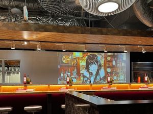 Japanese jazz and pop fill the room with vibrant visuals, while sake tasting and Chin-Chiro-Rin bring a playful taste of Japan—an entertaining dining experience unique to ENGINE. at ENGINE SHINJUKU RAMEN in Tokyo