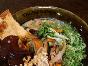 SHINJUKU GB - VEGAN / Signature ramen topped with savory ginger-sautéed veggies, rich mushroom blend, and roasted black garlic oil. / Allergy info: Wheat, Orange, Soy, Buckwheat at ENGINE SHINJUKU RAMEN in Tokyo