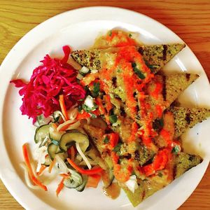 Seared polenta cakes with hemp seed crust and creamy pumpkin seed sauce  at Postcards in Hanalei