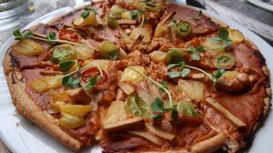 The vegan personal pizza - SO much more than we thought we'd get for a personal pizza! It is delicious - the "cheese" is in the base and kind of like nacho cheese, thicker and almost a bit sweet. The Living Foods ham (pretty sure its part of the Living Hut brand) on top was really good and the crust is always excellently baked! We've never been disappointed with this pizza and get it (so far!) every time we go!  at Mianto 艾果豐 in Taipei