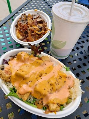 Reuben bowl with poutine bowl behind it, actually same size. Also a strawberry banana smoothie/shake. If you miss Nestle Strawberry Quik, get this! at The Farm Concessions and Café in Keene