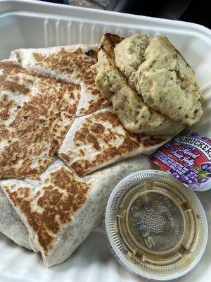 Breakfast Crunchwrap with a side of biscuits  at The Wayward Vegan in Seattle