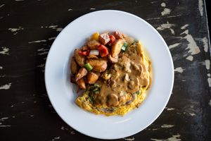 Mushroom Omelet (GF) 
Sautéed mushroom, spinach, cream cheese, mushroom gravy, with home fries.
(served until 3:30pm) at The Wayward Vegan in Seattle