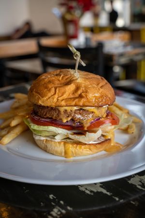All-American Burger
Burger patty, mayo, lettuce, tomatoes, sliced red onions, and cheddar cheese sauce. at The Wayward Vegan in Seattle