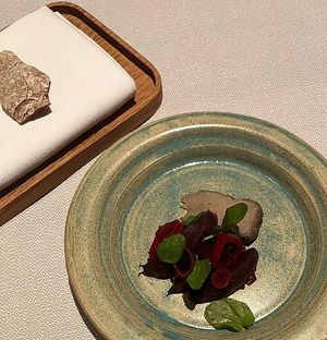 Piece of sunflower seed cheese   at TIAN Munich in Munich