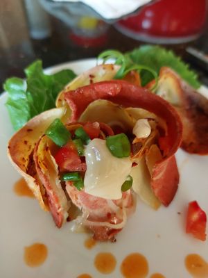 Vegan, potato slice and onion roll bake. Top with tomato salsa and to with vayonnaise and scallions. at Homey Food & Cafe in Calgary
