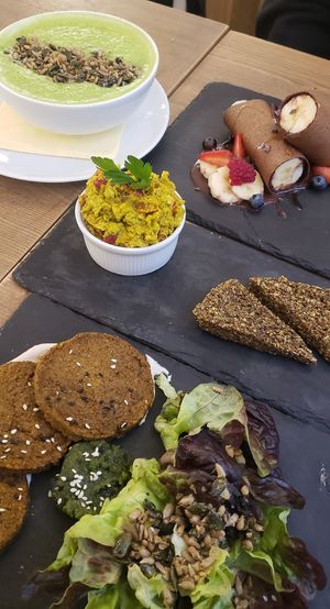 Pea soup, sweet pancakes (rolls), tofu/avocado "scrambled eggs", sweet potato patties at MyRaw Cafe in Prague