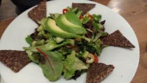 Salad with avocado and crakers at MyRaw Cafe in Prague