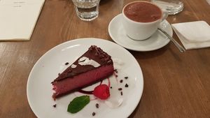 chocolate raspberry cheesecake with hot chocolate at MyRaw Cafe in Prague
