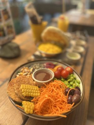 Vegan veggie bowl. Behind my husbands chicken. We always have a challenge finding what we both like to eat.   at Ona Beach Bar in Roses