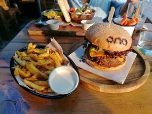 Fries with tahini mayo and vegan burger at Ona Beach Bar in Roses