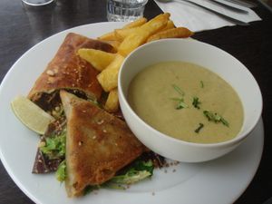 Variety meal with soup, fries, samosa, and sandwich. at Brasserie LoLa in Paris