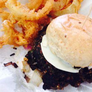 spicy vegan black bean burger with onion rings. at Go Vegan Grill in Decatur