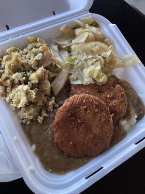 Smothered fried chicken, cabbage, and cornbread dressing  at Go Vegan Grill in Decatur