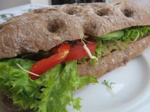 vegan sandwich with pea pate, lettuce, tomatoes, cucumber, sprouts at Schneider's in Frankfurt