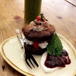 Chocolate cake with coco whip cream and chia jam, and green juice! at Nurcha Maroochydore in Buderim