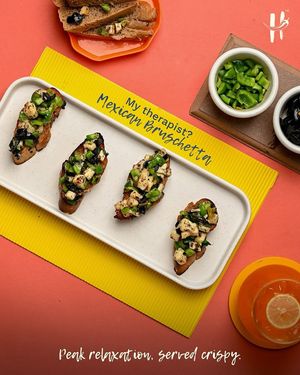 Mexican Bruschetta at Hoggeterians – Crispy toasted bread topped with fresh veggies, zesty Mexican flavors, and vibrant seasonings for the perfect fusion appetizer. at Hoggeterians - Fusion Restaurant in Gujarat