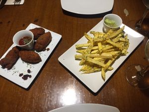 Croquettes and garlic fries- with real garlic!!!yum! at Fargo in Sevilla