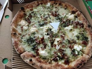 Whole wheat base, double basil pesto, red pesto, vegan mozzarella (just because), goat cheese, blue cheese (gorgonzola), parmesan, ricotta, pine nuts. Best pizza ever! at Pizza Di Rocco in Abu Dhabi