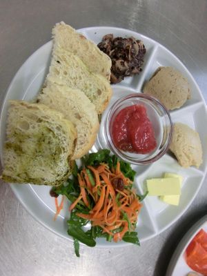 Vegan breakfast with humus, mutabal, salad, fruits salad, raw fruit jam and house made rice-bread at Coco Genki in Berlin
