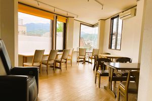 Bright dining room with large windows and views over the surrounding Saga-Arashiyama area.
 at Ermine's Kitchen in Kyoto