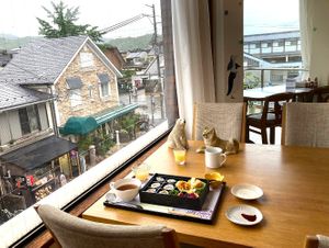 Window-side dining at Ermine’s Kitchen, with views over Saga-Arashiyama and a freshly served vegan bento. at Ermine's Kitchen in Kyoto