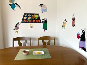 A cozy dining corner decorated with whimsical wall stickers. at Ermine's Kitchen in Kyoto